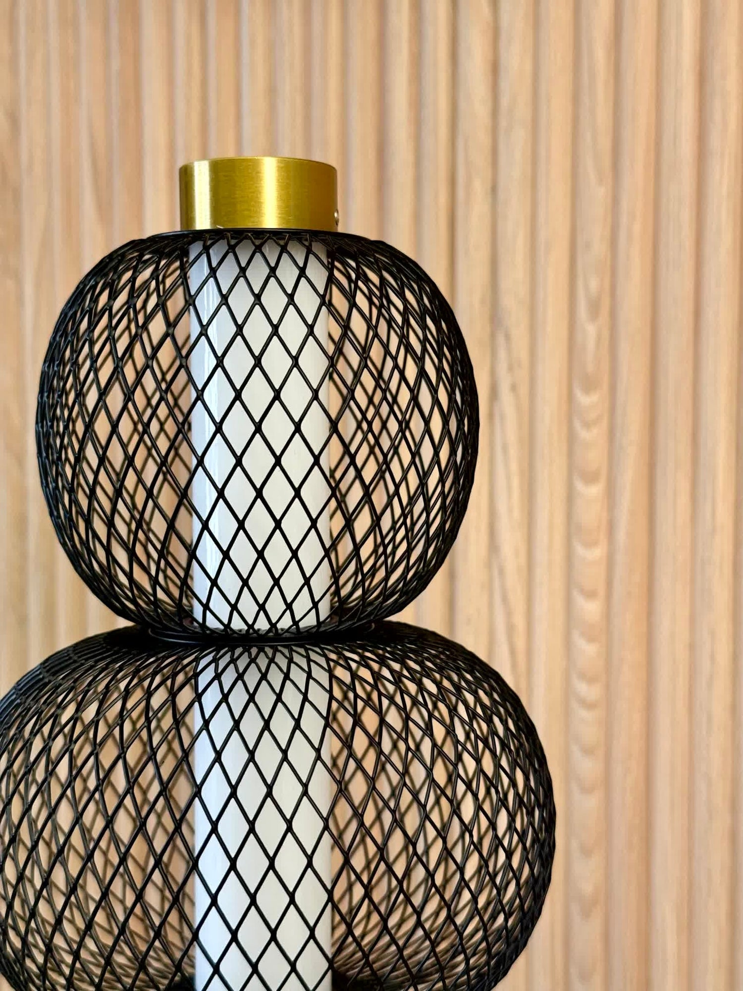 High Objects Trinity Slim Mesh Table Lamp with stacked black mesh spheres, brushed gold accents, and white light core.