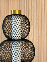 High Objects Trinity Slim Mesh Table Lamp with stacked black mesh spheres, brushed gold accents, and white light core.