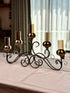 High Objects Valencia Scroll Five-Arm Candle Stand with bronze finish and amber glass holders.