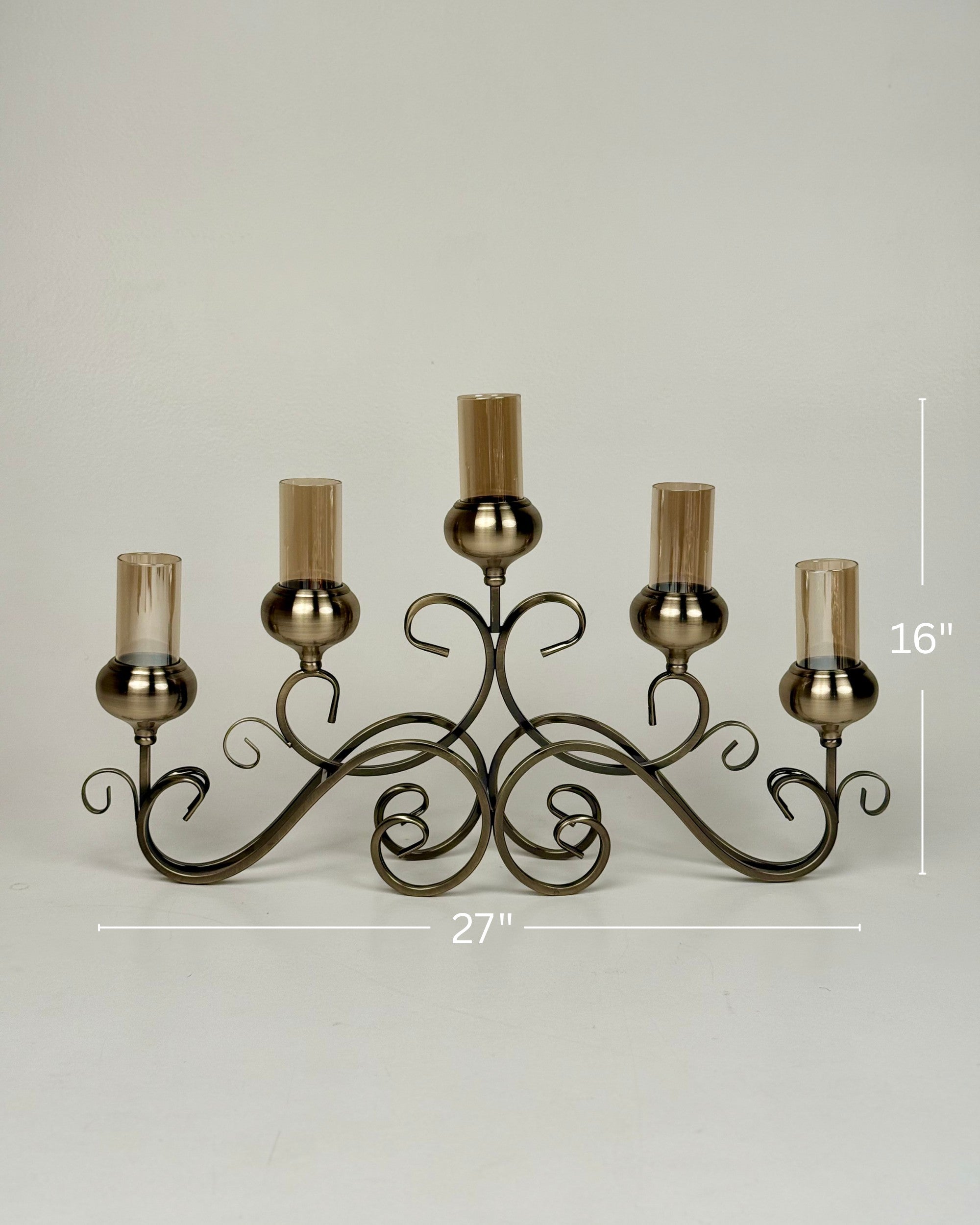 High Objects Valencia Scroll Five-Arm Candle Stand with amber glass holders and ornate metalwork.