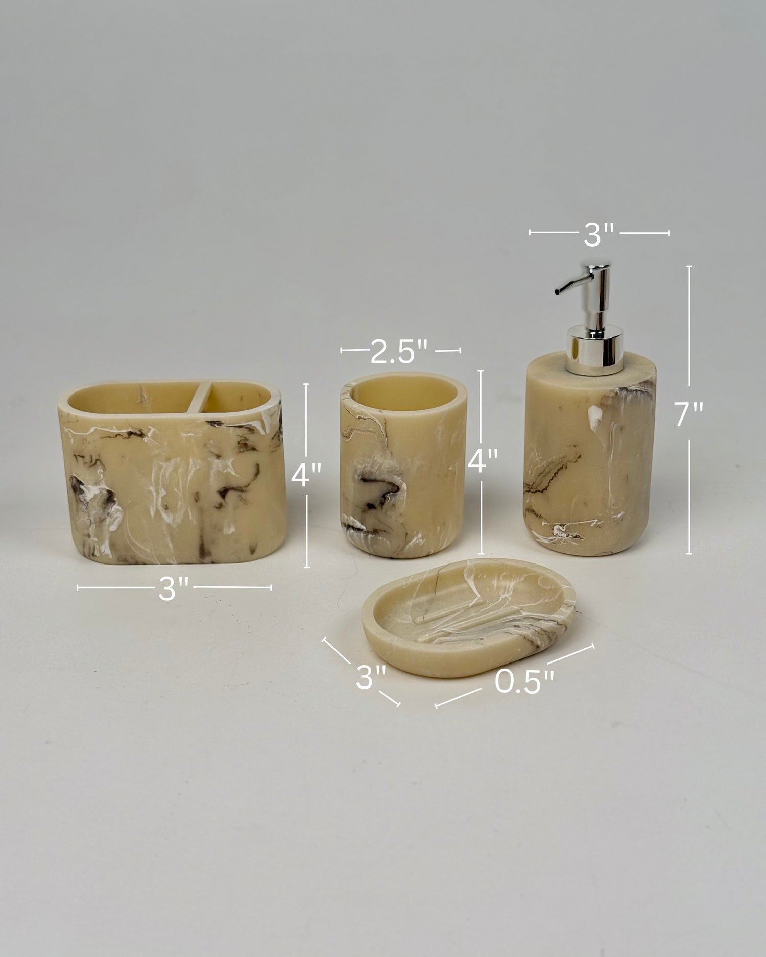 High Objects Veinstone Bathroom Accessory Set with soap dispenser, toothbrush holder, cup, and soap dish in beige with marbled veining.