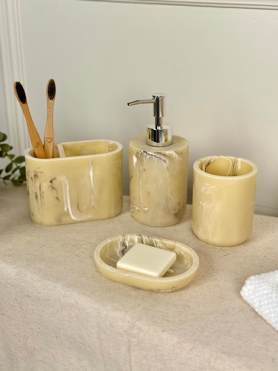 High Objects Veinstone Bathroom Accessory Set: soap dish, dispenser, toothbrush holder, and cup in cream with brown veining.