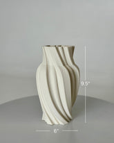 High Objects Volara Vase, a 9.5" tall ceramic vase with a matte off-white finish and a unique twisted, fluid design.