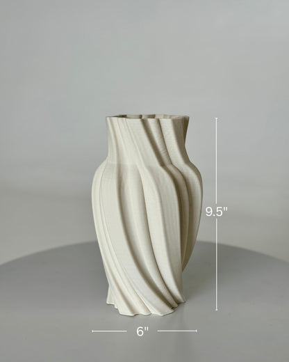 High Objects Volara Vase, a 9.5" tall ceramic vase with a matte off-white finish and a unique twisted, fluid design.
