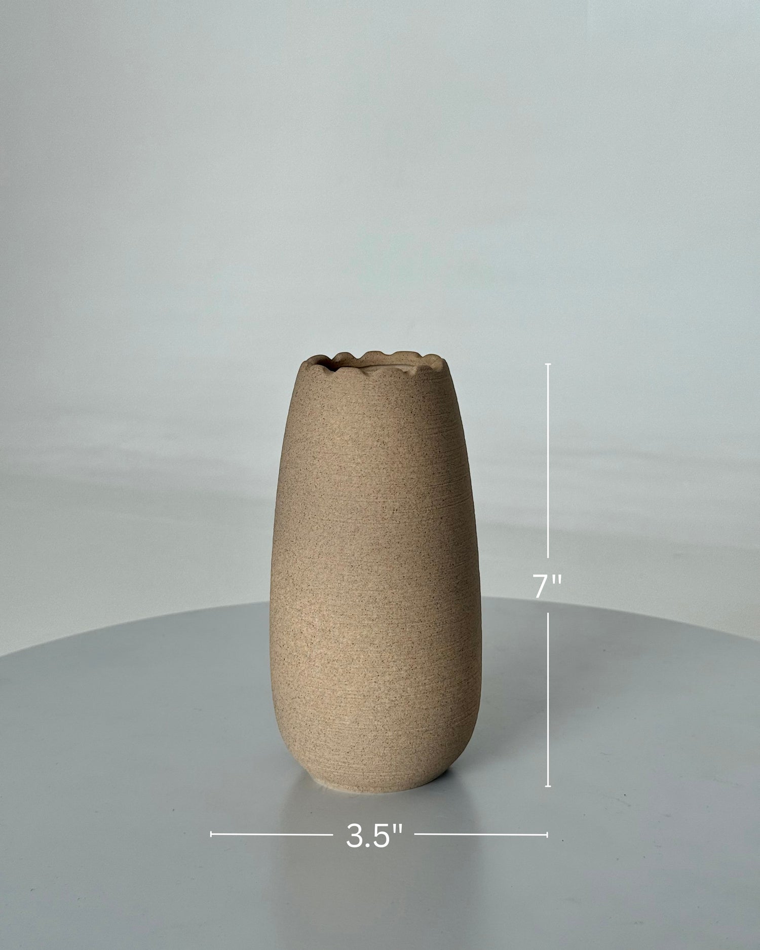 High Objects Waveform Ceramic Vase, 7" tall, 3.5" diameter, with a textured earthy finish and wavy rim.