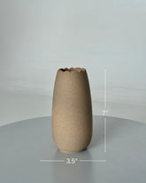 High Objects Waveform Ceramic Vase, 7" tall, 3.5" diameter, with a textured earthy finish and wavy rim.