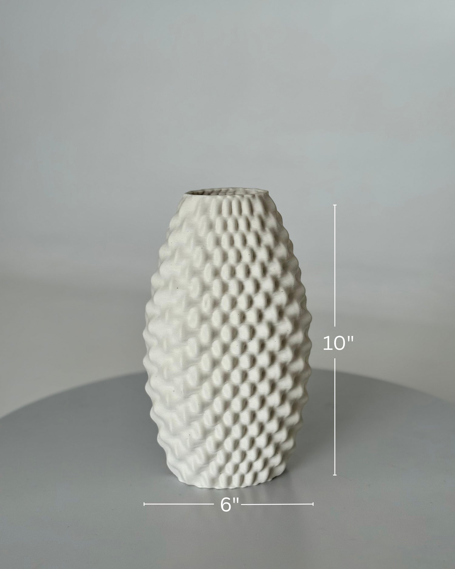 High Objects Arisca Vase, a 10" tall white ceramic vase with a 3D printed textured wave pattern.