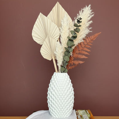 High Objects Arisca Vase, white ceramic with textured wave pattern, holding dried botanicals.