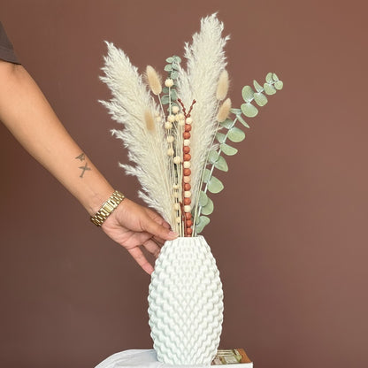 High Objects Arisca Vase, white ceramic with textured wave pattern, holding dried pampas grass and eucalyptus.