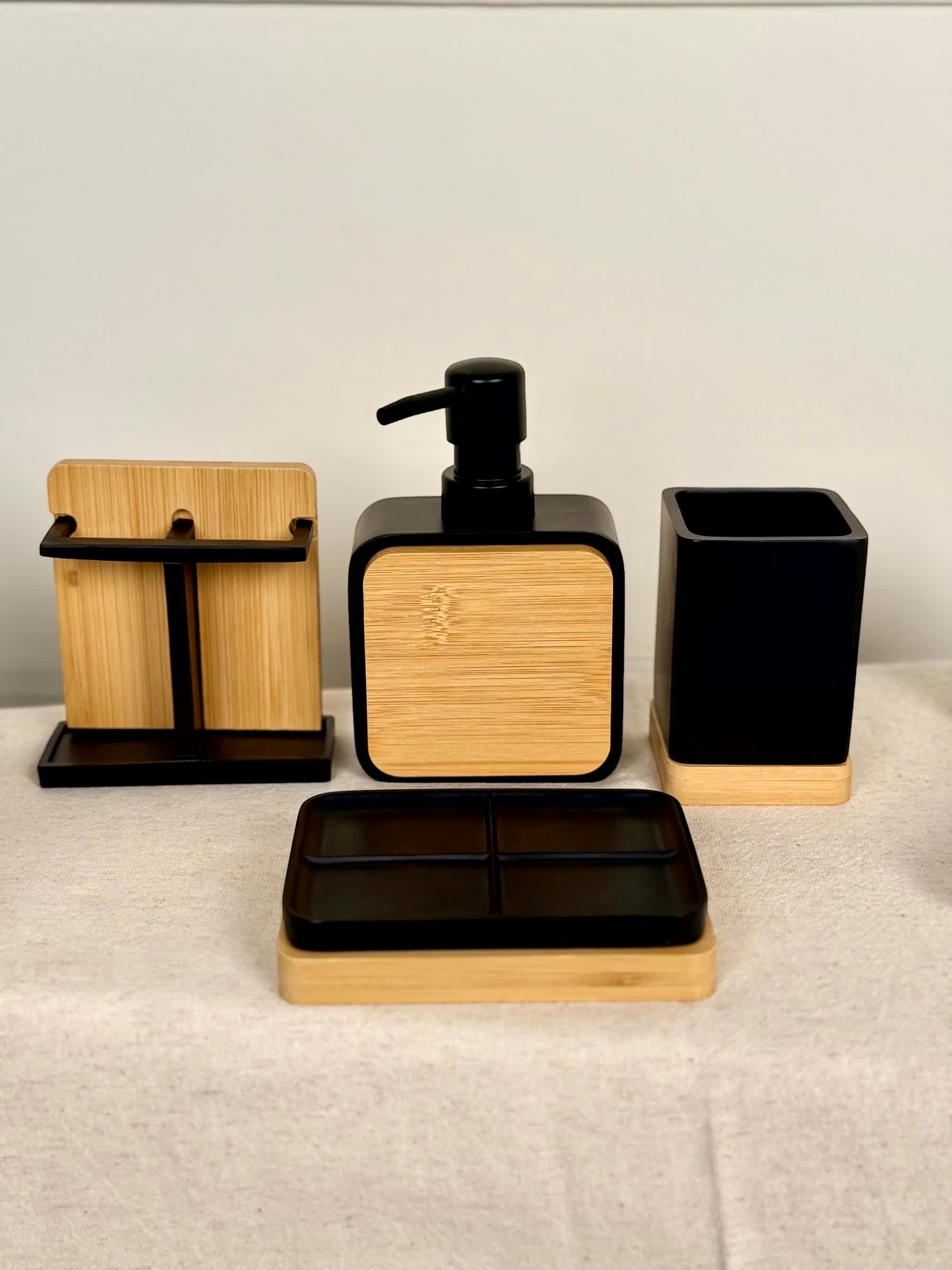 High Objects Zenform Bathroom Essentials Set: black and bamboo soap dispenser, toothbrush holder, cup, and tray.