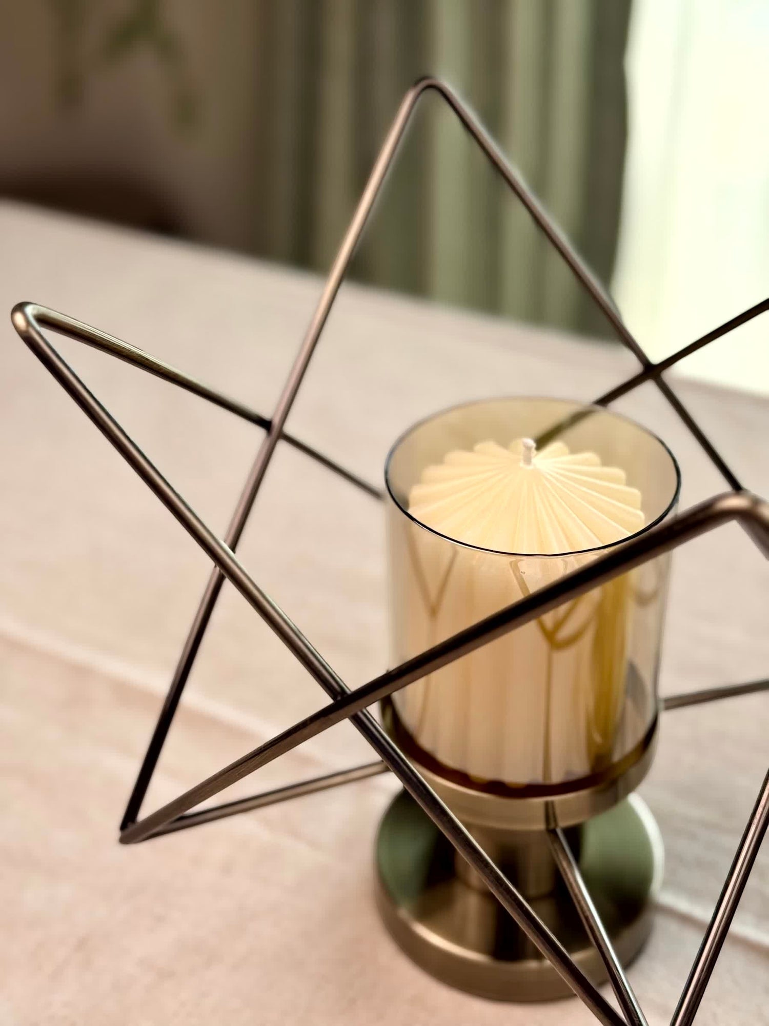 High Objects Zigzag Geo candle stand set with a cream candle in a tinted glass holder, brushed metal base.