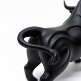 High Objects black matte bull showpiece with curved horns and muscular body, poised for action.
