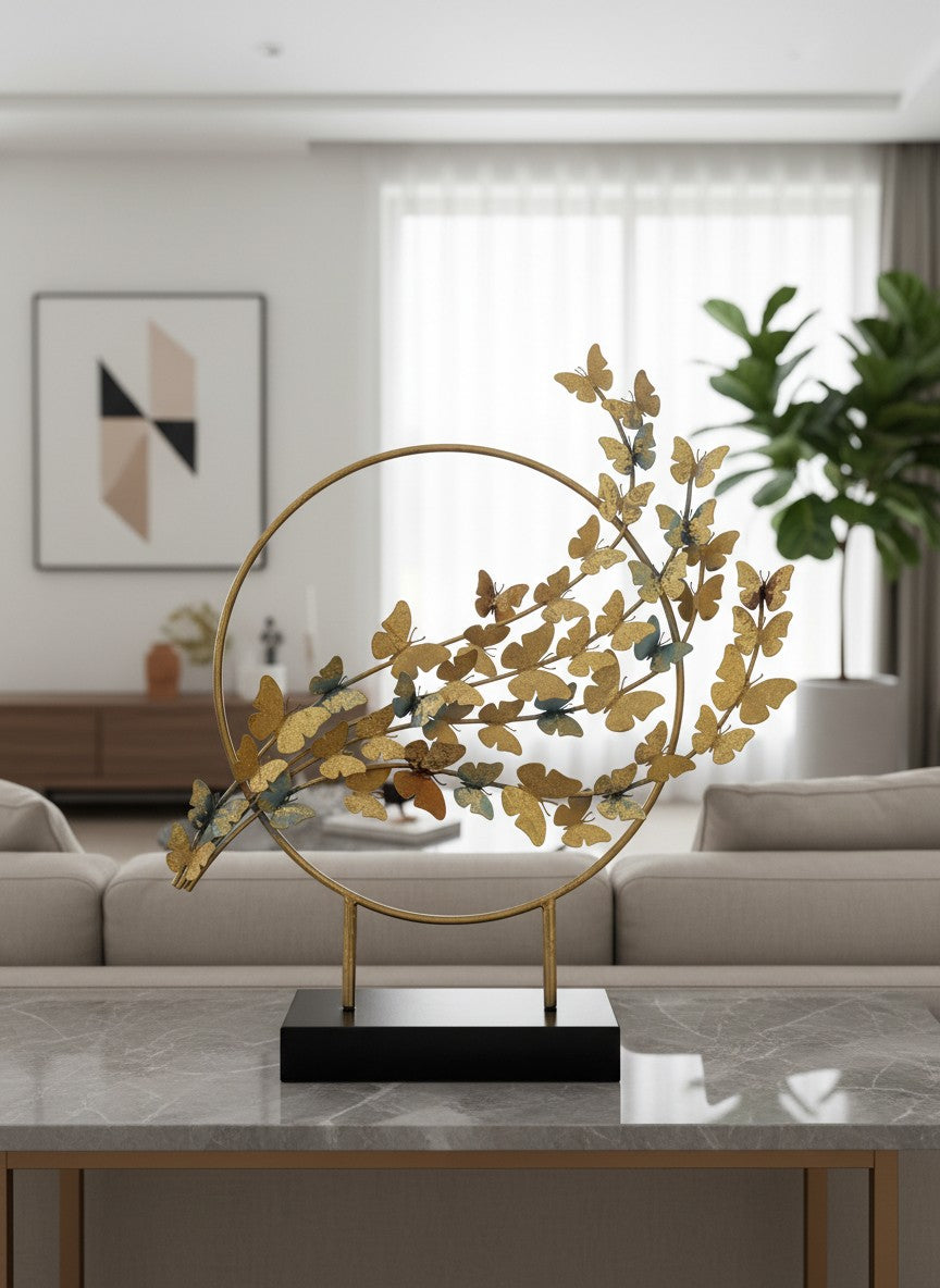 High Objects gold metal showpiece with a circular frame and a branch adorned with numerous golden butterflies.