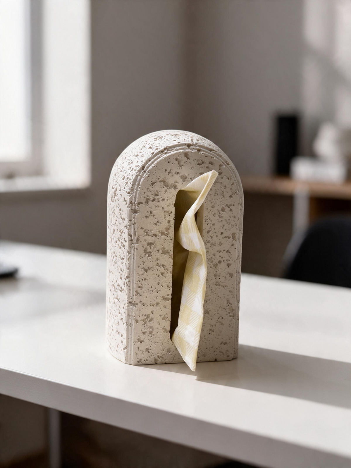 High Objects Olea white tissue box with a rough stone-like texture and a modern arched design on a desk.